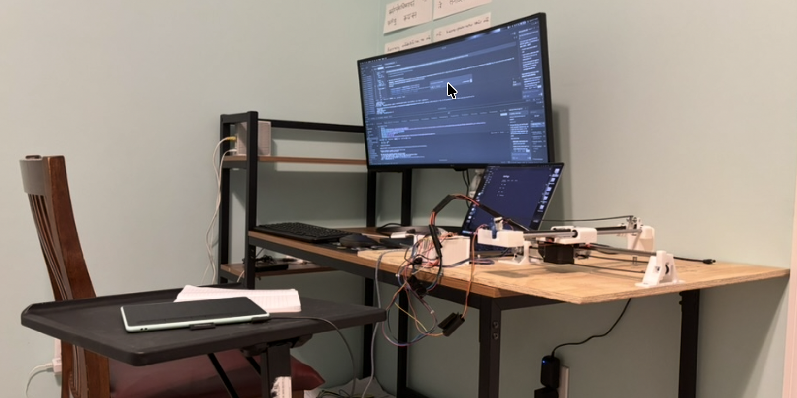 Desk with monitors and the CNC plotter